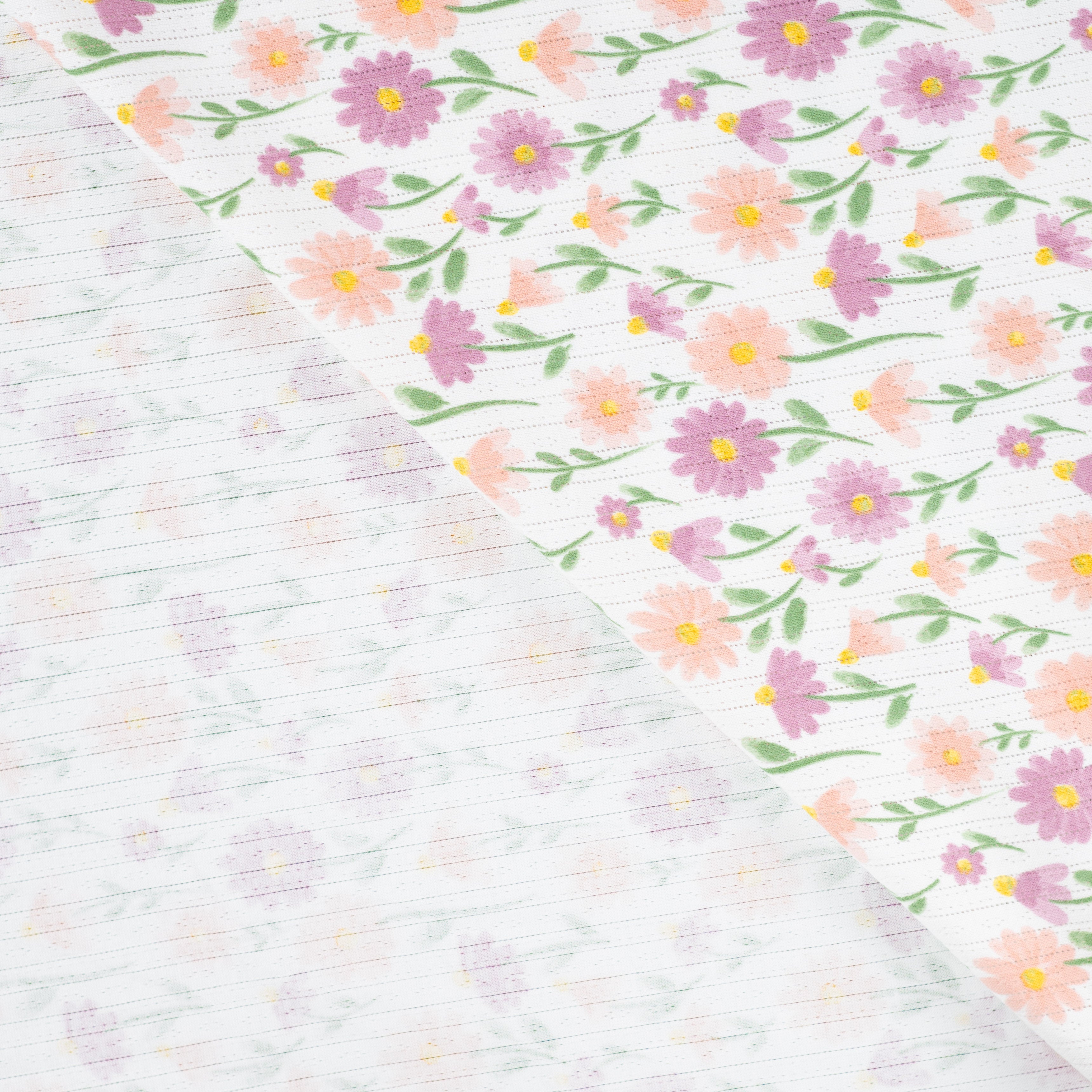 Tissu Jersey Ajouré Pâquerettes pastel