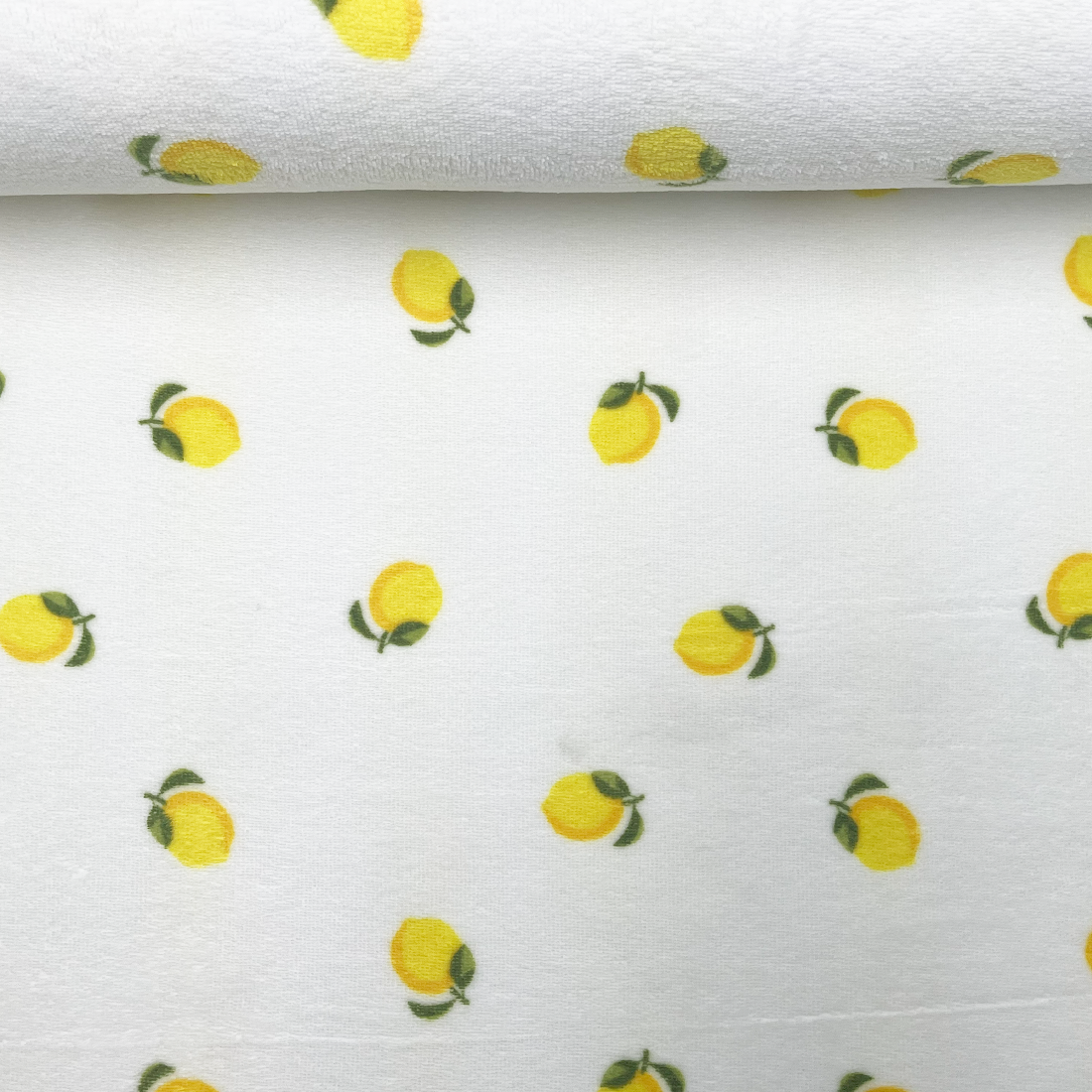 Tissu éponge blanc décoré de citrons jaunes
