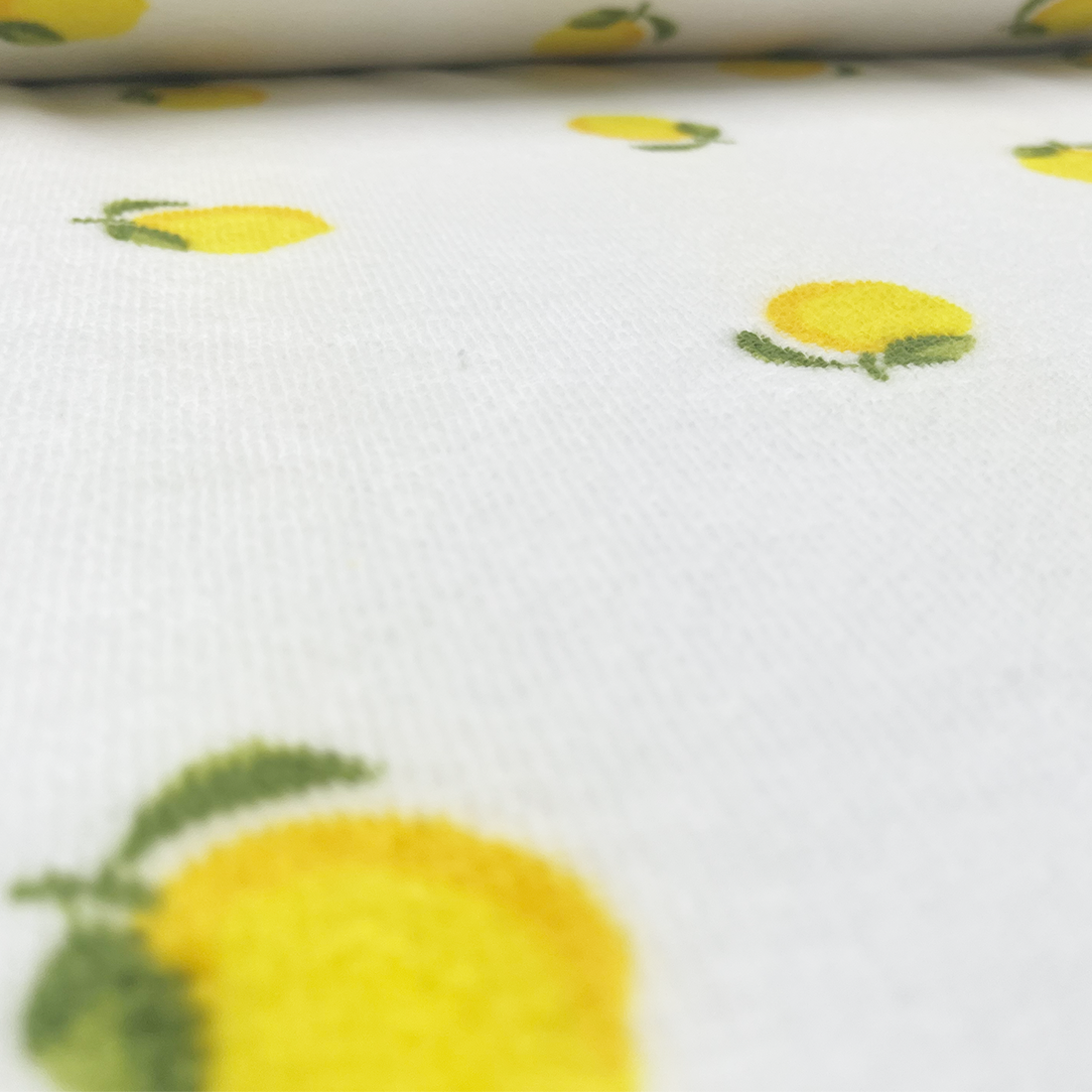 Tissu éponge motif citrons sur fond blanc