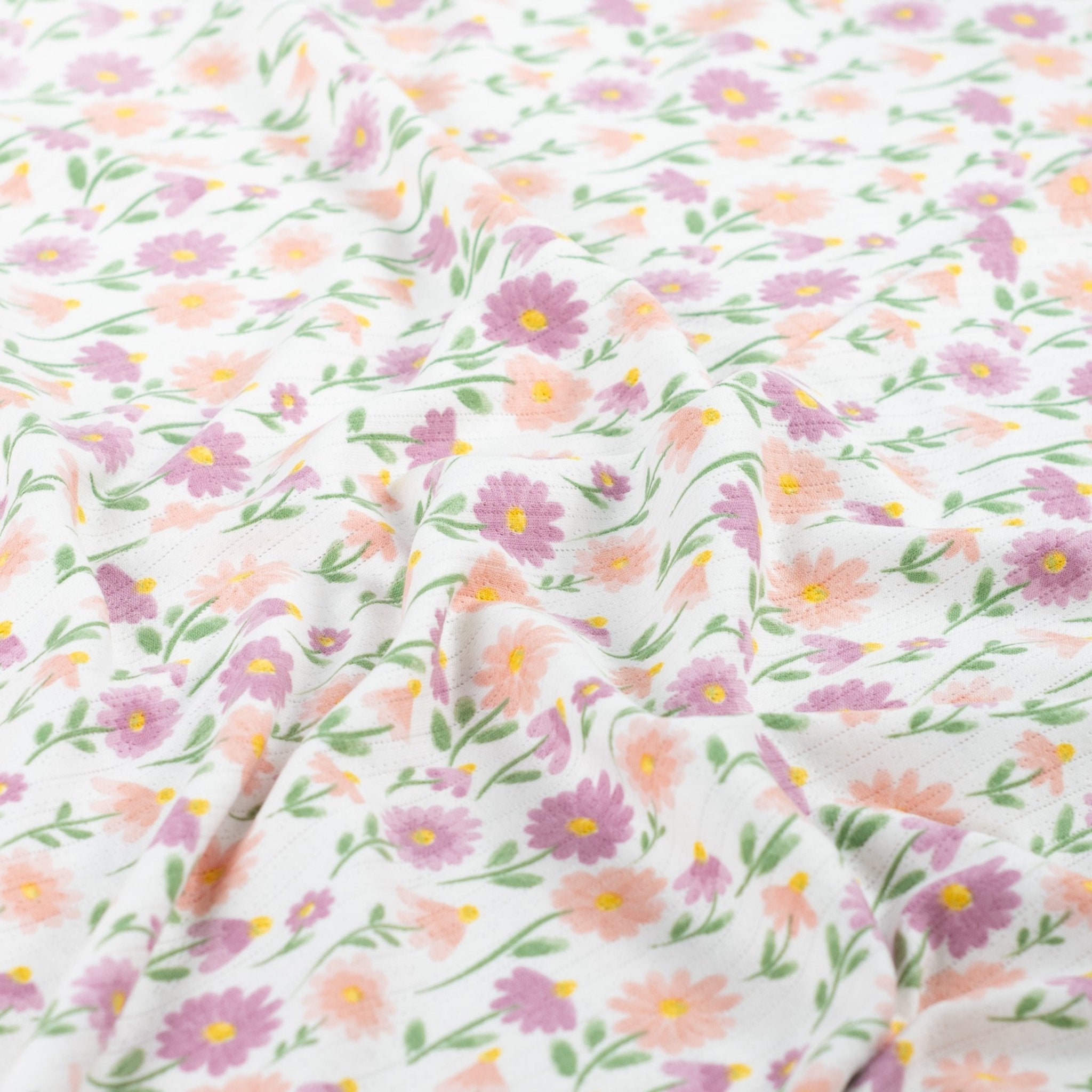 Tissu Jersey Ajouré Pâquerettes pastel
