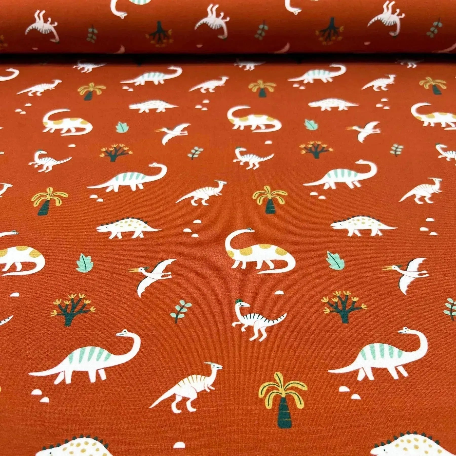 Tissu jersey de coton dino fond terre