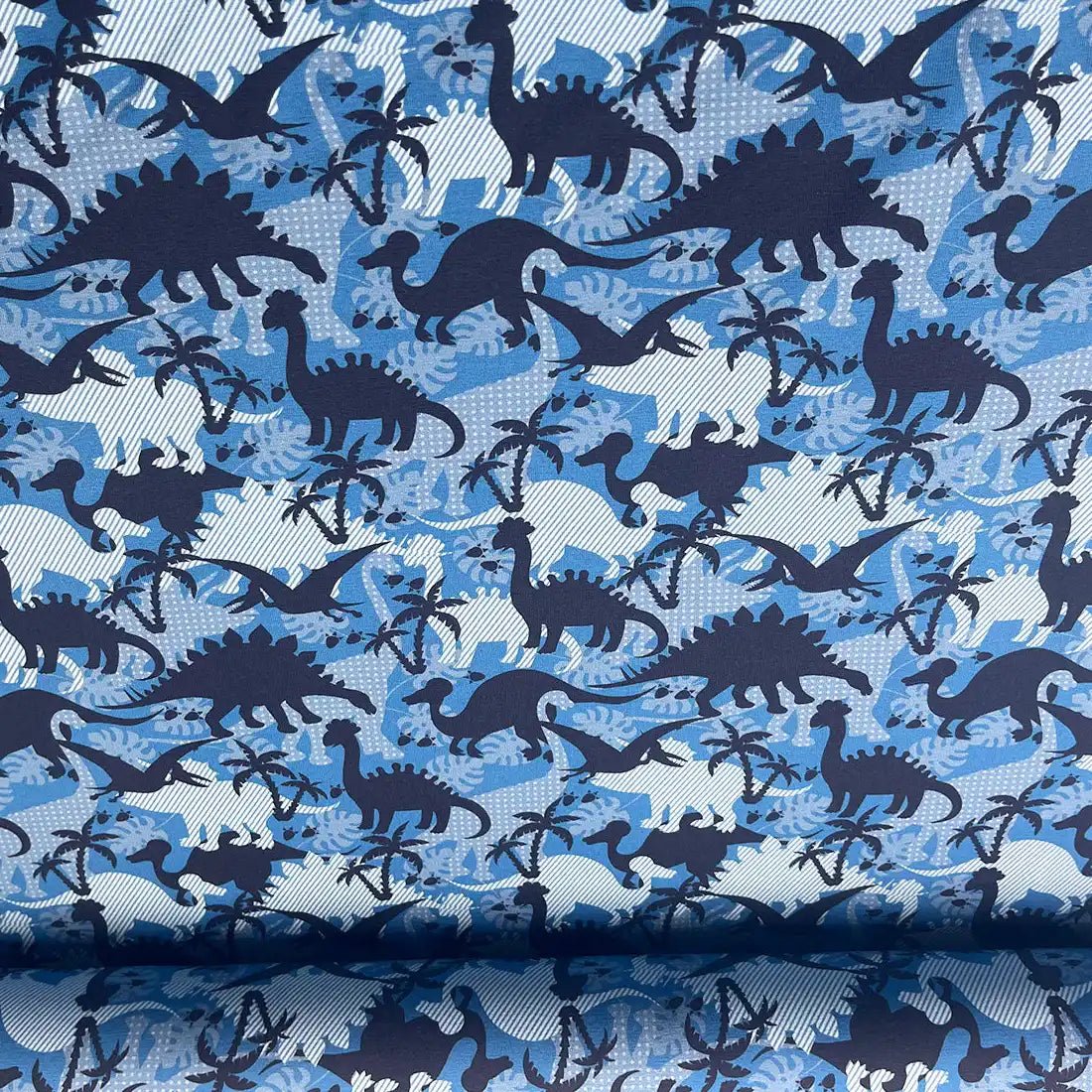 Tissu jersey imprimé dinosaures – bleu et blanc