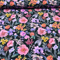 Jersey de coton fond noir imprimé fleurs exotiques violettes et roses