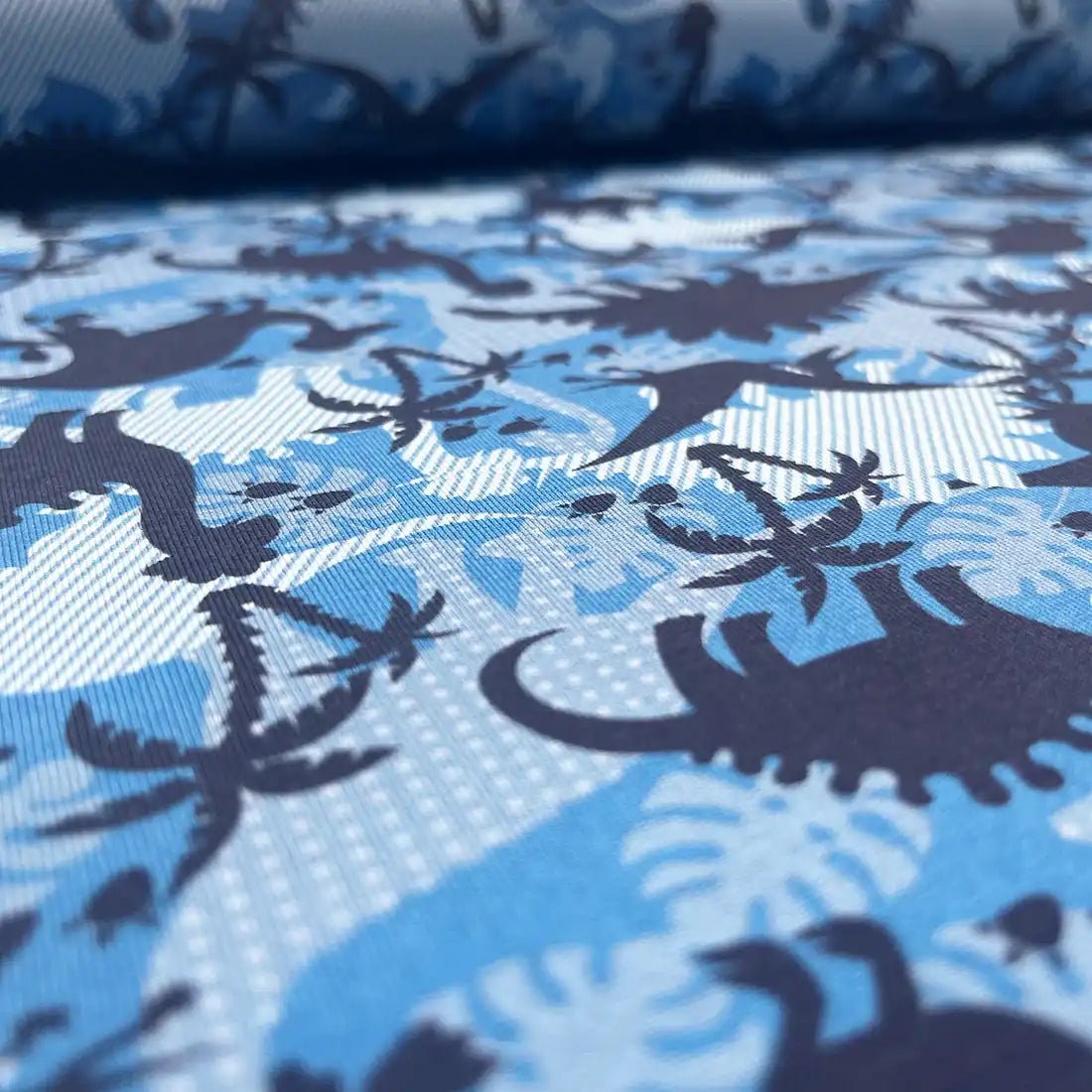 Tissu jersey imprimé dinosaures – bleu et blanc